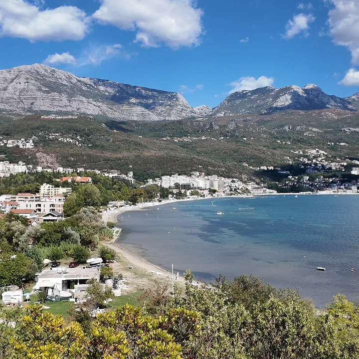 The bay of Igalo curving away below a hillside, Orjen behind it and the town strung along the water