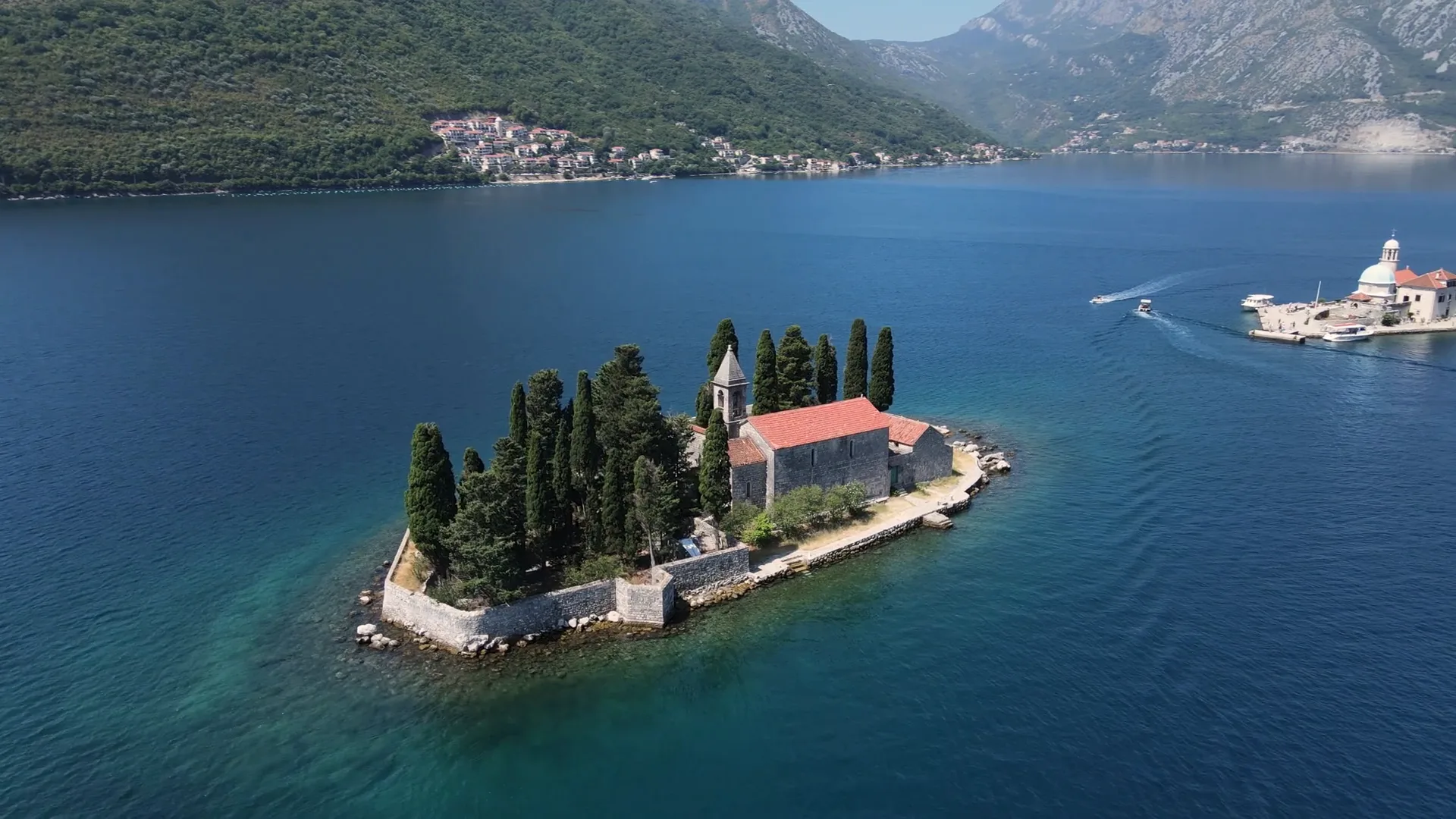 The two islets off Perast, Our Lady of the Rocks with its domed church and neighbouring St George, seen from the air.
