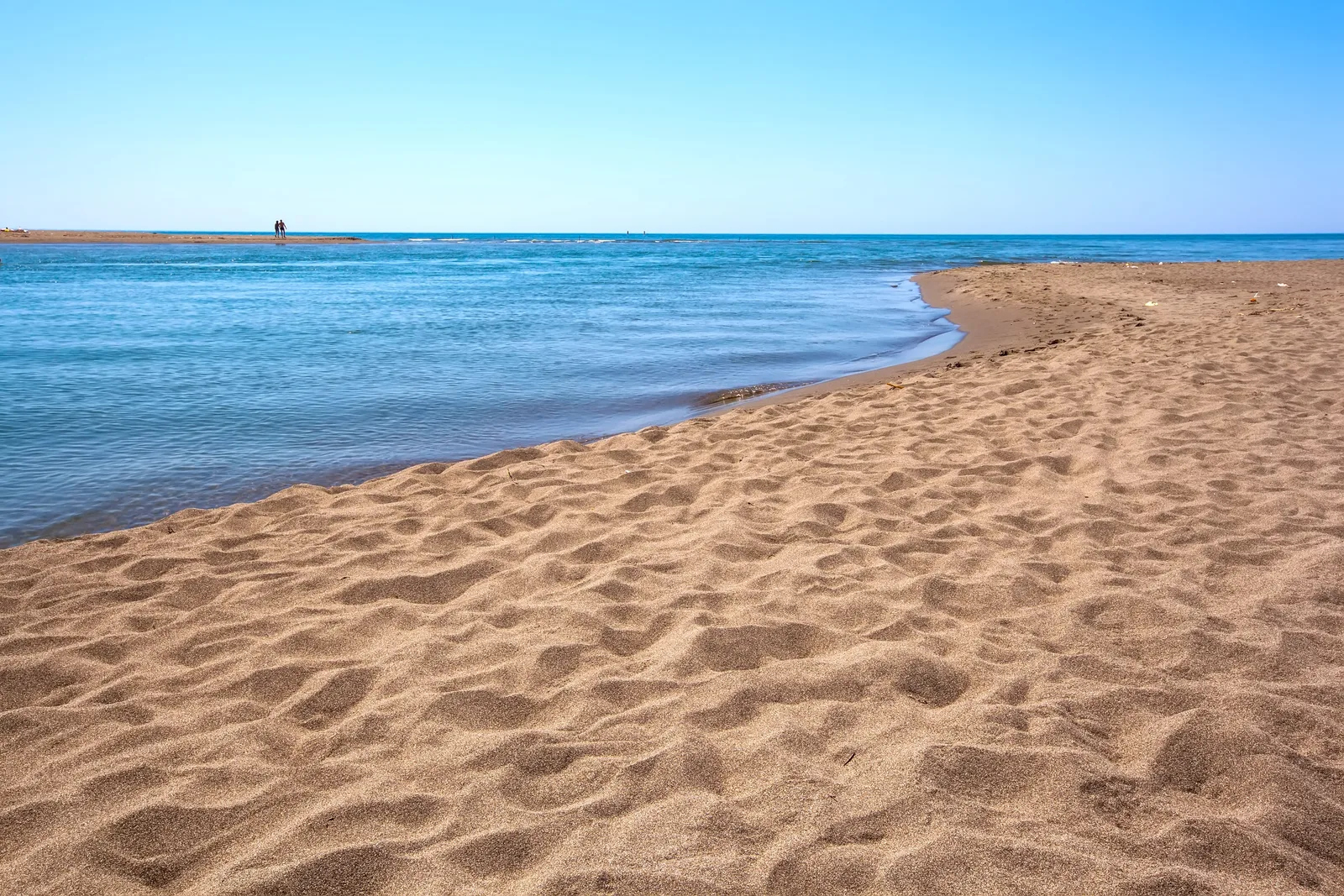 The wide sandy beach and sandbar where the Bojana river island meets the Adriatic Sea