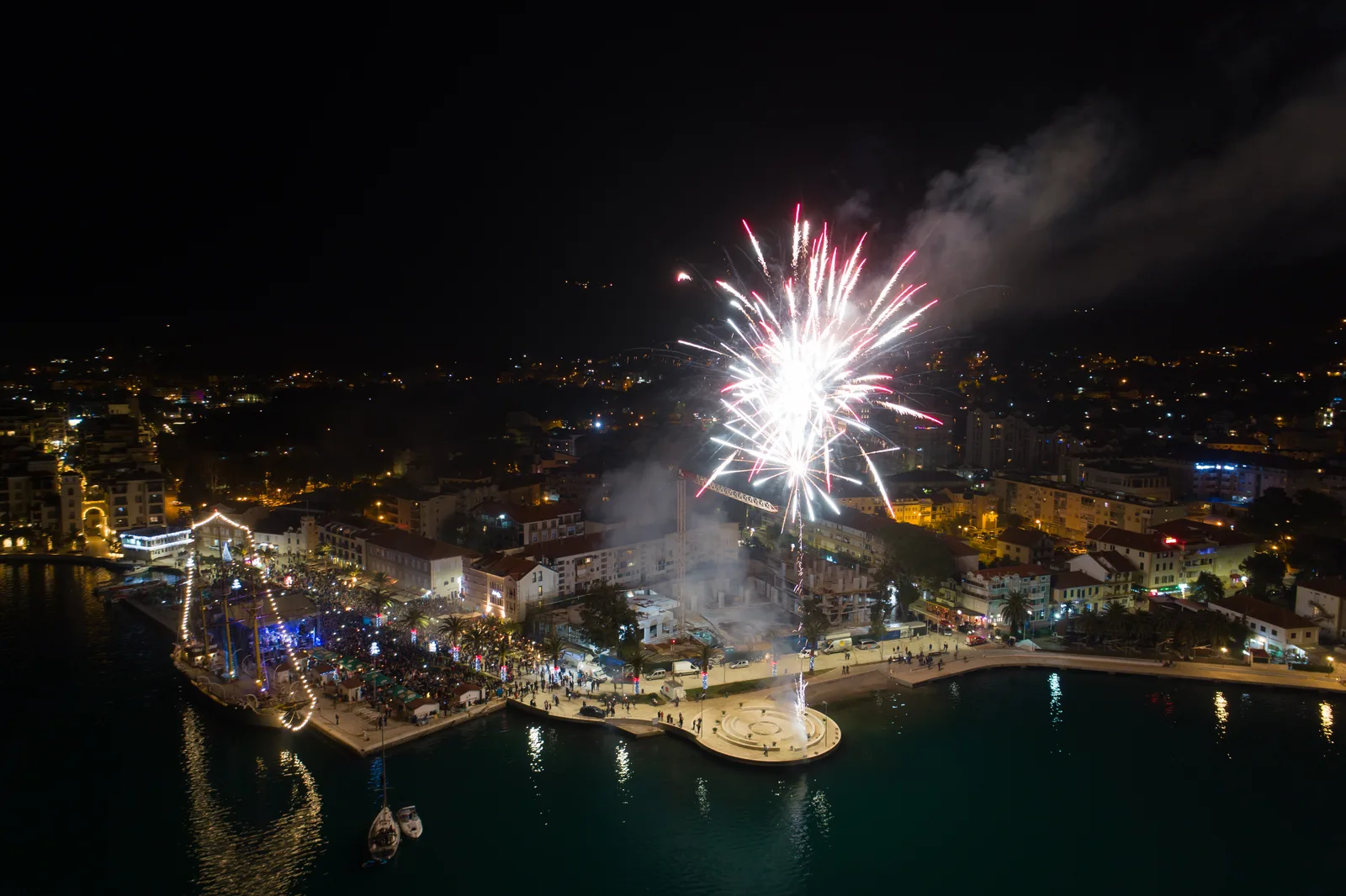Fireworks bursting over an Adriatic waterfront town in Montenegro during a national celebration