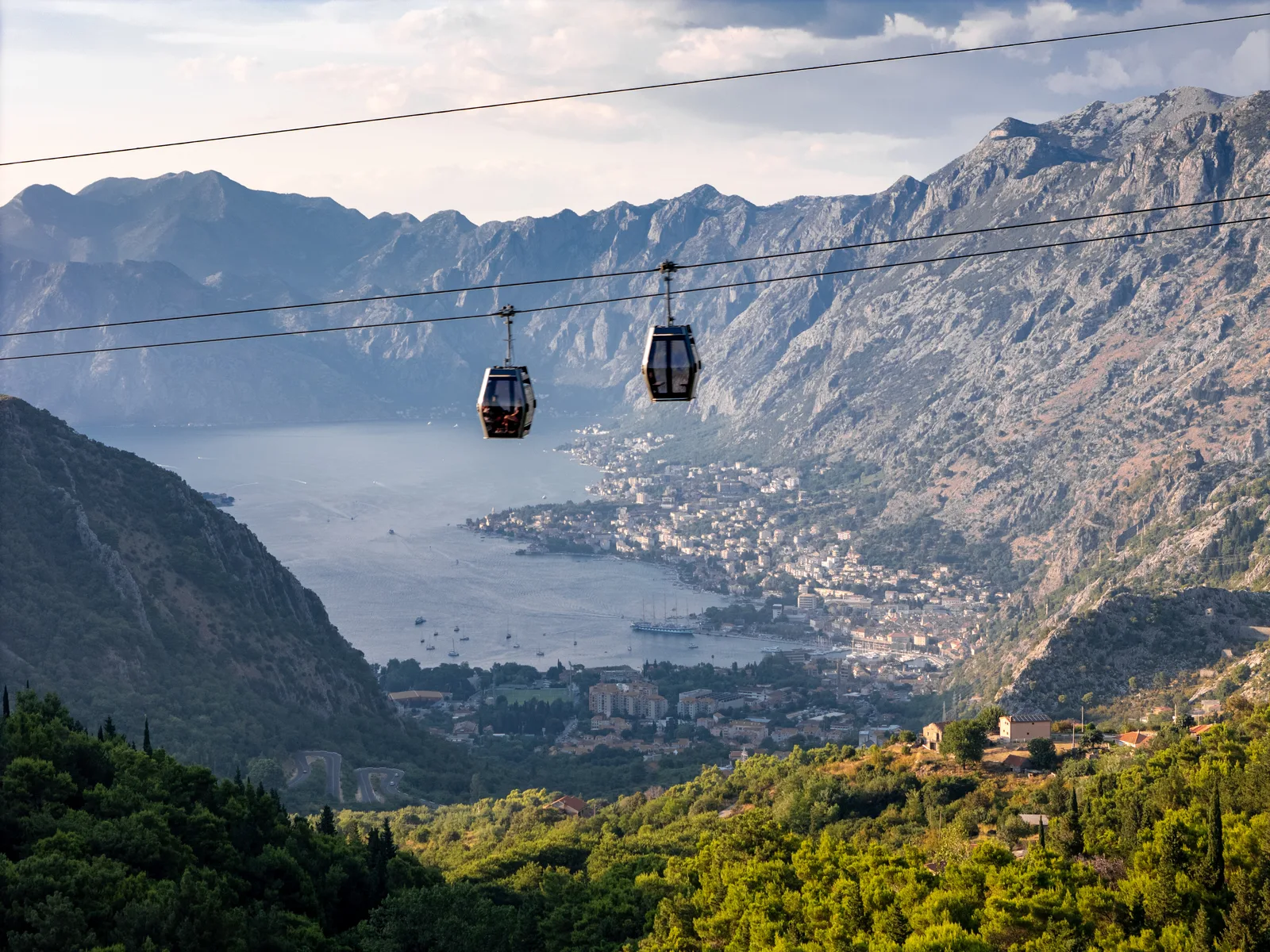 Cable car gondolas crossing high above the Bay of Kotor