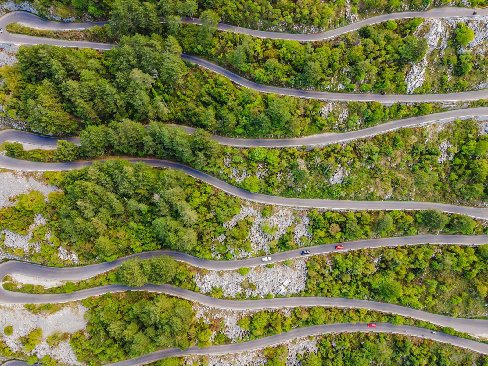 Aerial of the serpentine switchback road climbing above Kotor and its bay