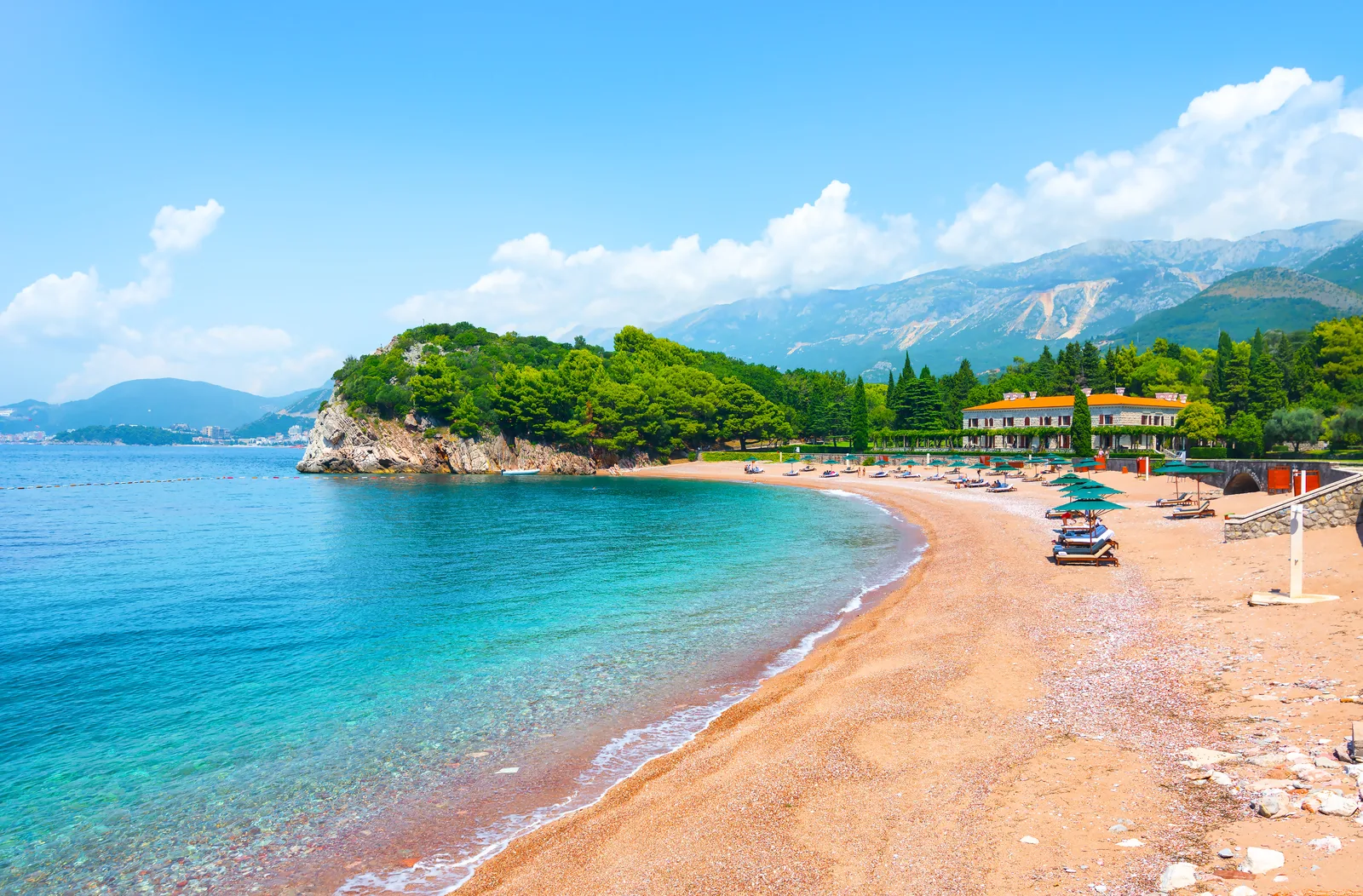 Milocer beach with its pink sand, pine forest and the former royal villa on the Budva Riviera