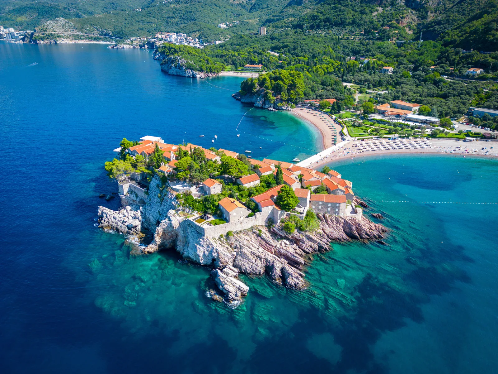 Aerial view of the Sveti Stefan islet, its terracotta-roofed stone village and the turquoise Adriatic