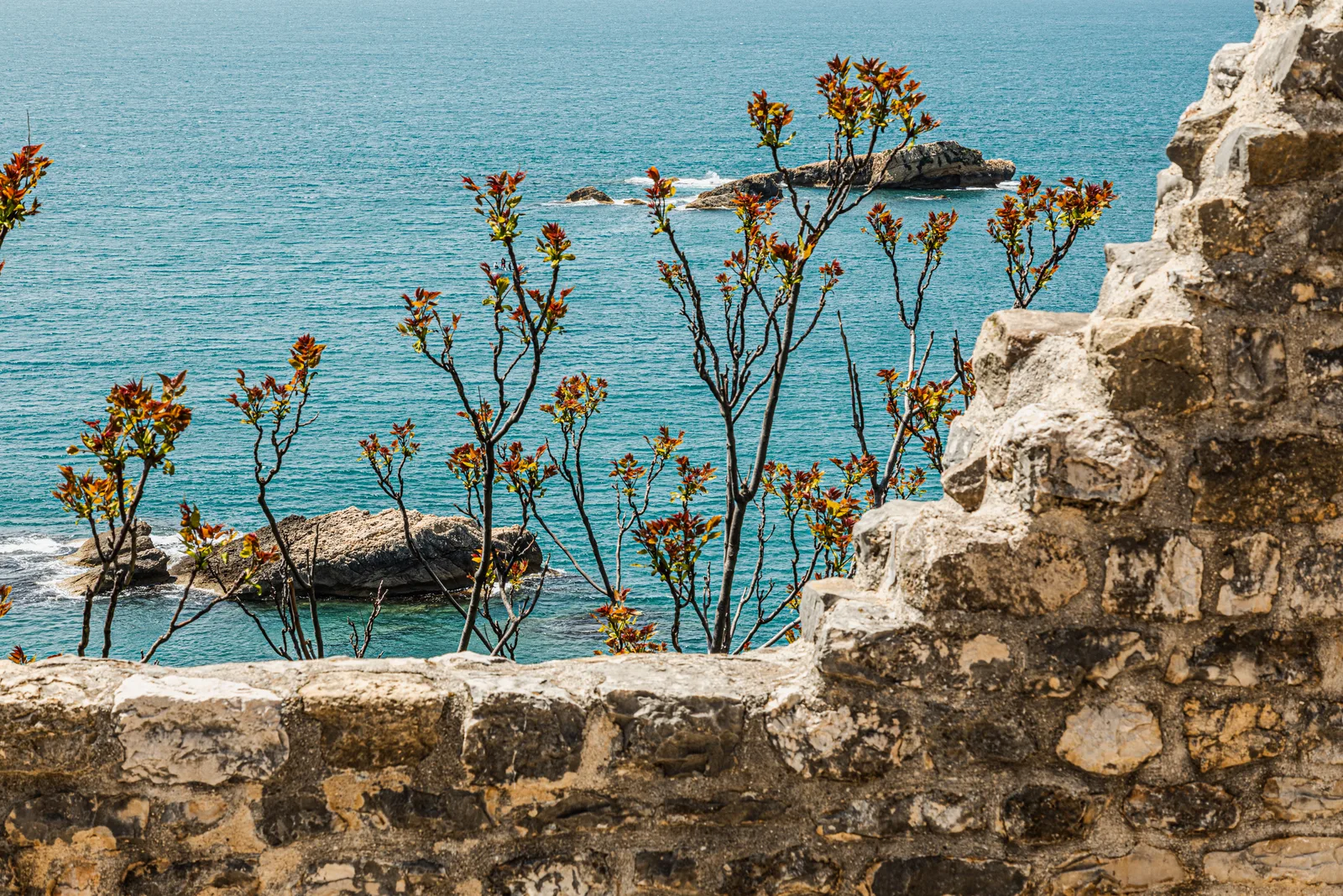 Old fortress stonework above the clear Adriatic at Ulcinj Old Town