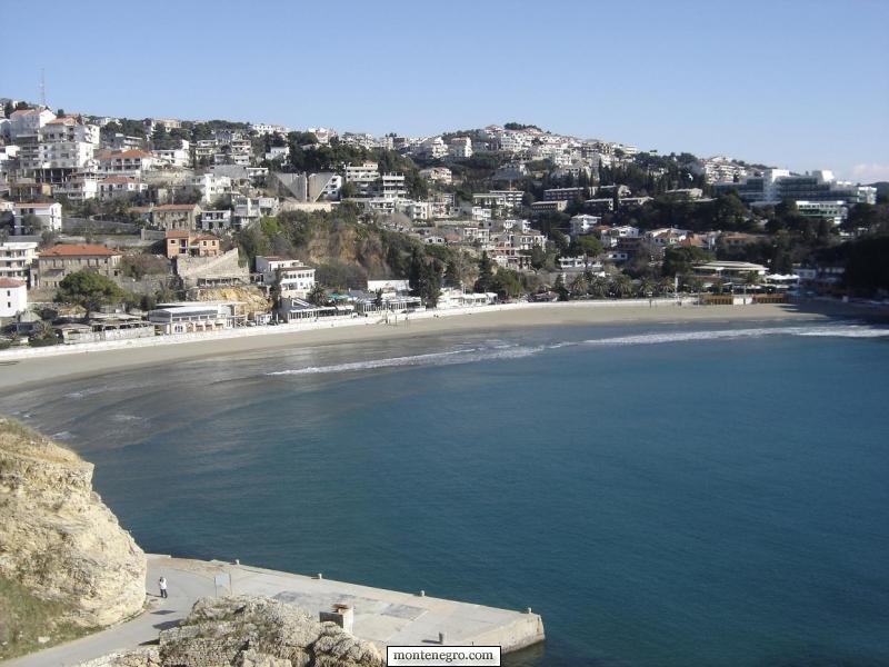 The town of Ulcinj rising above the Adriatic coast, with stone houses and the old citadel beside the sea