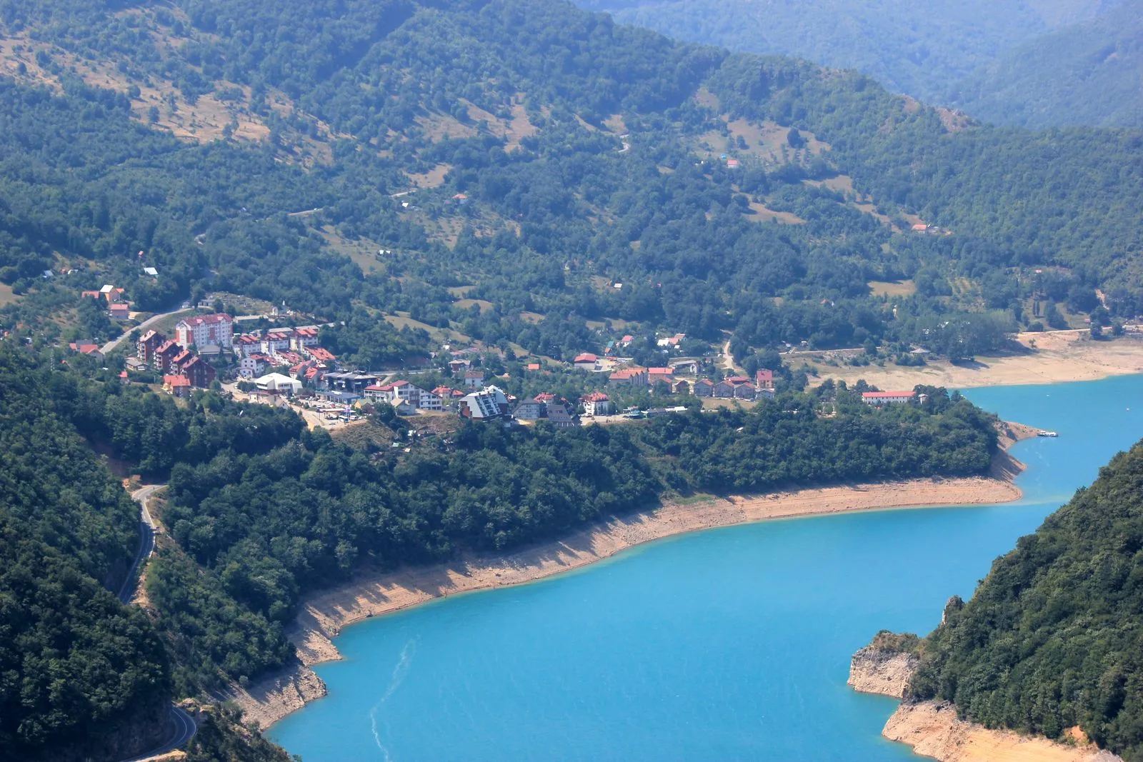 Plužine today, the town spread along the shore of Piva Lake beneath the surrounding mountains.