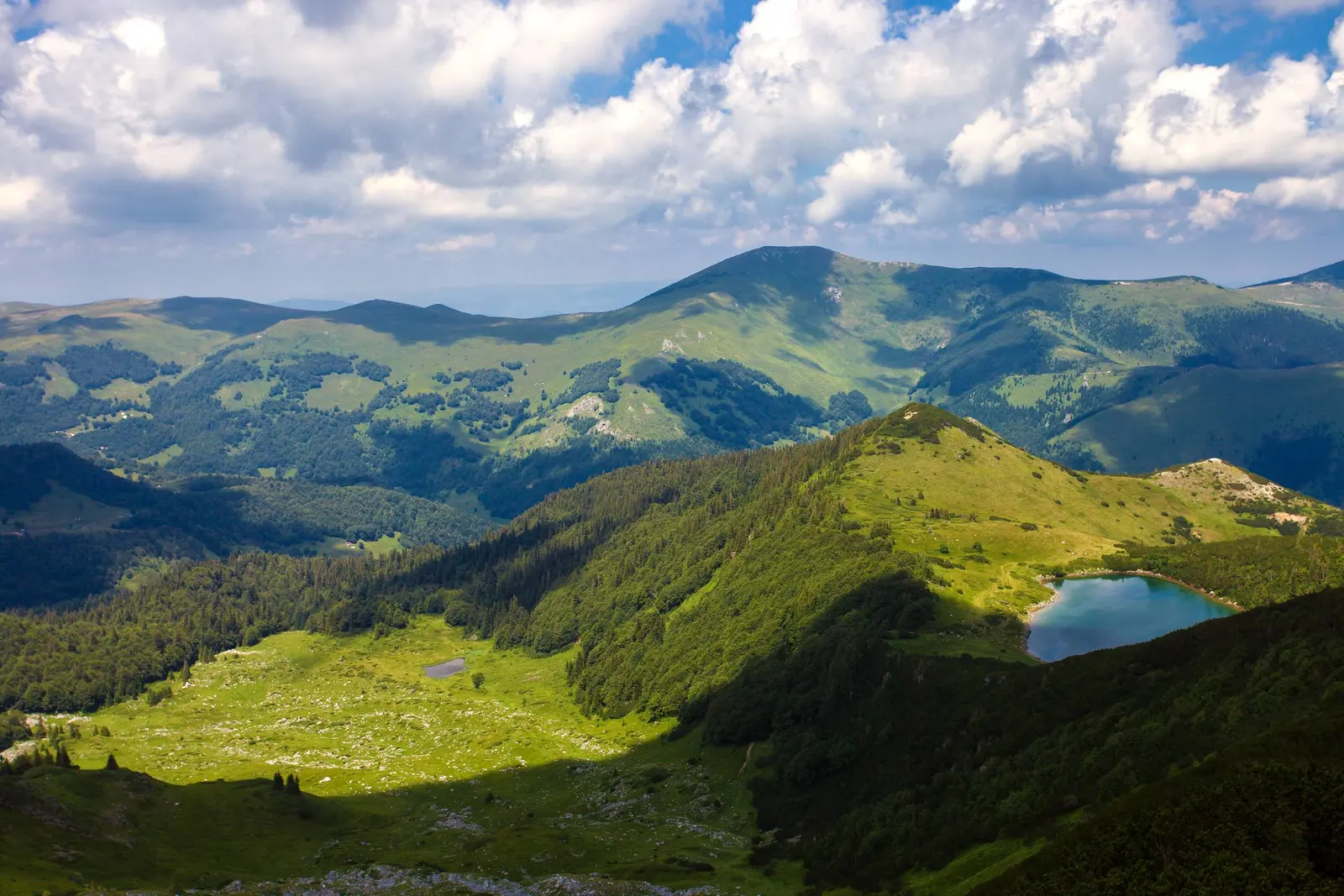 Ursulovačko glacial lake beneath the green ridges of Bjelasica